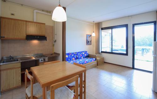 a kitchen and living room with a table and a couch at Lovely Apartment In San Feliciano in San Feliciano