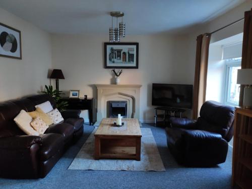 a living room with a couch and a coffee table at Main Street Swinford! in Swinford