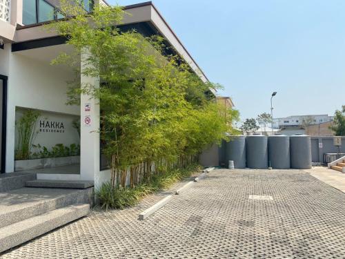 a building with a plant on the side of it at HAKKA Wellness Residence in Samut Songkhram