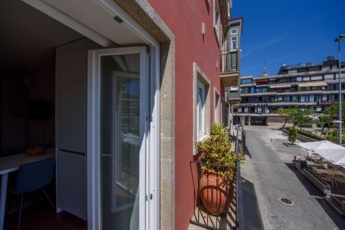 a balcony of a building with an open door at Terro Collection - Eça de Queirós in Braga