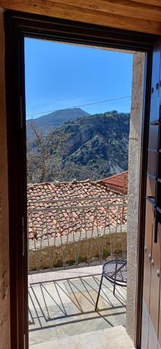 a sliding glass door with a view of a roof at Casagli Luxury Suites in Dhimitsana