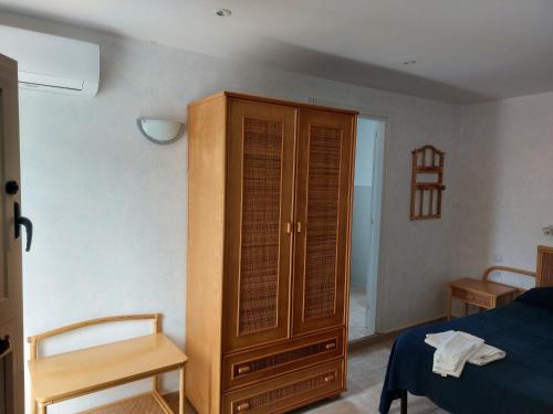 a bedroom with a wooden cabinet and a bed at Hotel Piccolo Mondo in Acquappesa