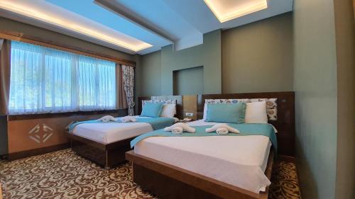 Ένα ή περισσότερα κρεβάτια σε δωμάτιο στο Sapanca Aqua Wellness Spa Hotel