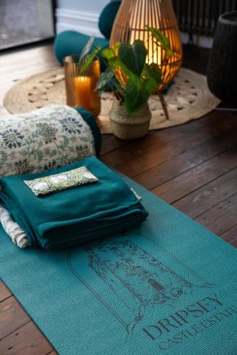 a blue rug on a wooden floor with a lamp and a table at Dripsey Castle Estate in Dripsey