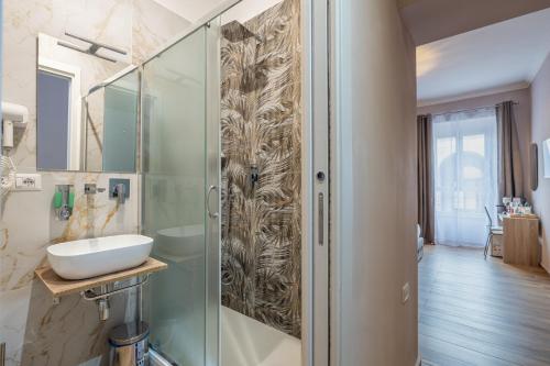 a bathroom with a glass shower and a sink at Affittacamere Casalí in Rome