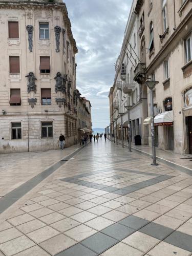 a city street with buildings and people walking on it at Apartment Dome in Split
