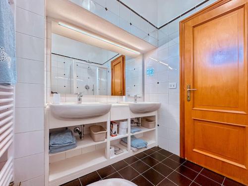 Un baño con dos lavabos y un espejo. en [5Terre]Nel Verde sul Mare - Relax in the Greenery, en Sestri Levante