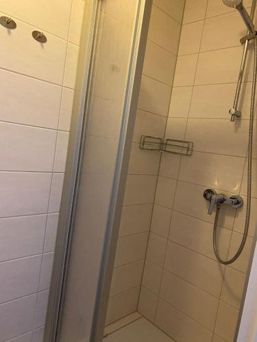 a shower with a glass door in a bathroom at Pension Feist Zimmer 2 in Dagebüll