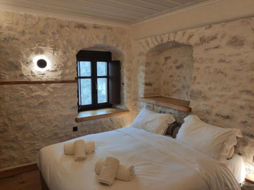 a bedroom with a bed with two towels on it at Casagli Luxury Suites in Dhimitsana