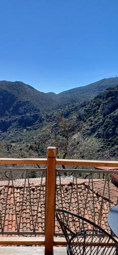 a wooden railing with a view of a mountain at Casagli Luxury Suites in Dhimitsana