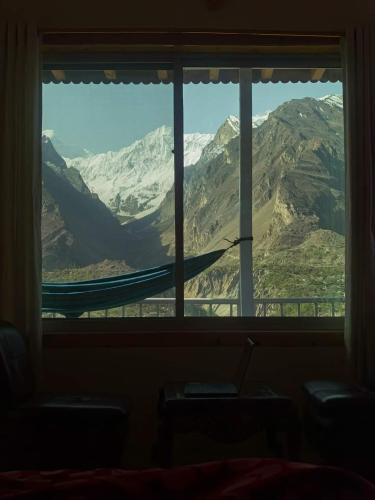 a window with a view of a mountain view at Hunza Lounge in Hunza