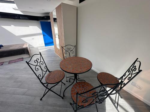 a table and four chairs in a room at Hovk Farms in Dilijan