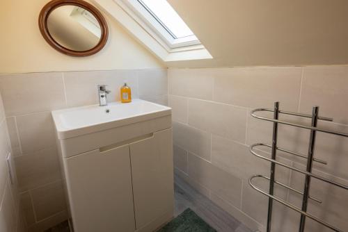 a bathroom with a sink and a skylight at Beckfoot Chapel Stile - Ambleside in Chapel Stile