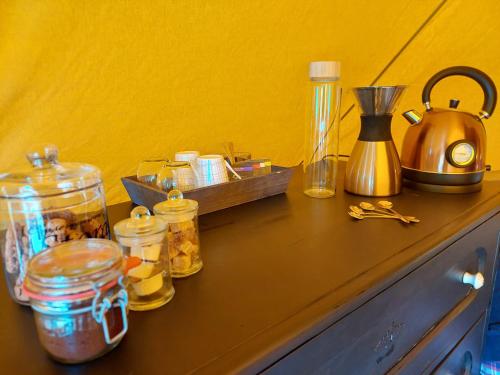 a counter with jars and a tea kettle on it at Glamping Hoeve Thenaers in Gingelom