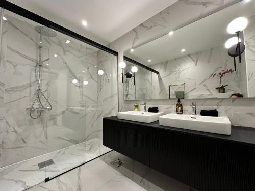 a bathroom with two sinks and a shower at Ambassador Tallinn in Tallinn
