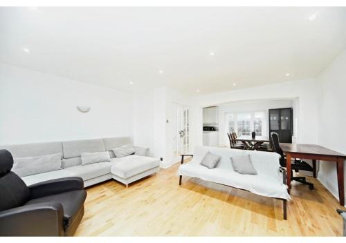 a living room with a couch and a table at 5BR Family Home close to Parks and City Links in Purley