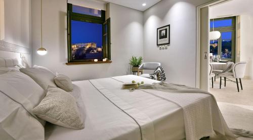 a white bedroom with a large bed and a dining room at Charming Athens Villa | 1 Bedroom | Villa Kyoraku | Panoramic Acropolis View | Platia Agion Asomaton in Athens