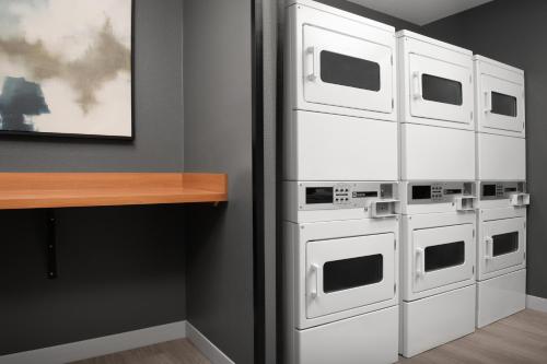 a room with three microwaves hanging on a wall at TownePlace Suites by Marriott Cheyenne Southwest/Downtown Area in Cheyenne