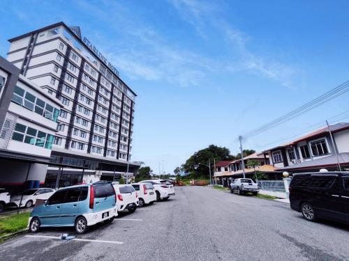 un parking avec des voitures garées devant un bâtiment dans l'établissement Tar1 @ ONE Homestay, 4 Bedroom, à Sibu
