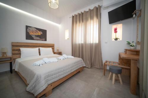 a bedroom with a bed with two towels on it at Elixrysos Apartment 2 in Pitsidia