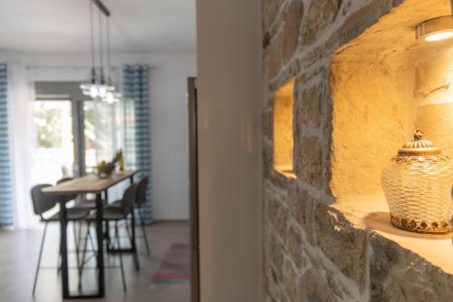 a room with a stone wall with a vase on a shelf at Elixrysos Apartment 2 in Pitsidia