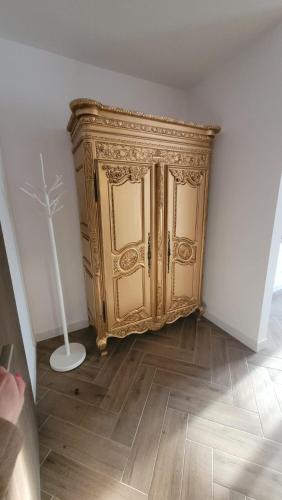 a gold cabinet in the corner of a room at APARTAMENT JARACZA 28/15 in Słupsk