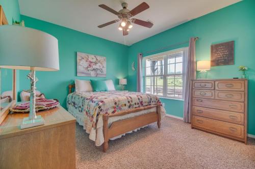 a bedroom with a bed and a dresser and a window at Peaceful Cameron Getaway about 5 Mi to Poteau! 