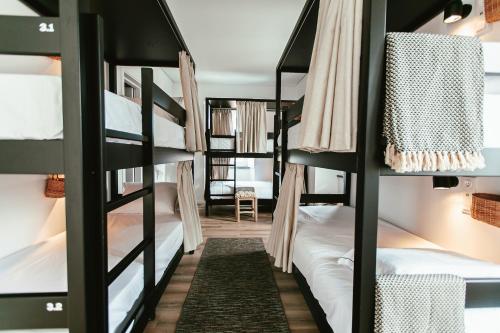 a room with bunk beds in a hostel at Aires Hostel in São Roque do Pico