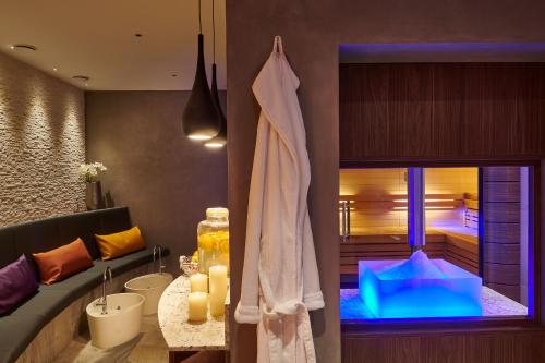 a bathroom with a bath tub and a room with a sink at Hotel Fontana in Bad Kissingen