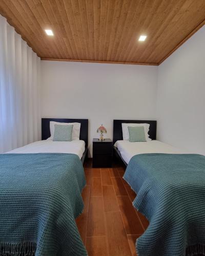 two beds sitting next to each other in a room at Quinta da Canda in Cerva