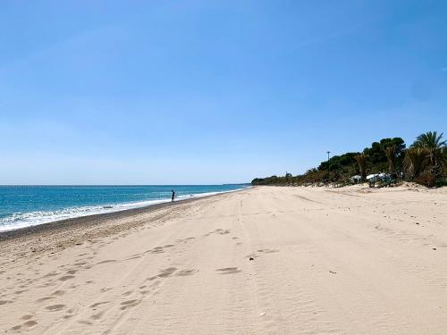 a sandy beach with a person standing on it at Camping La Torre del Sol - Maeva Vacansoleil in Miami Platja