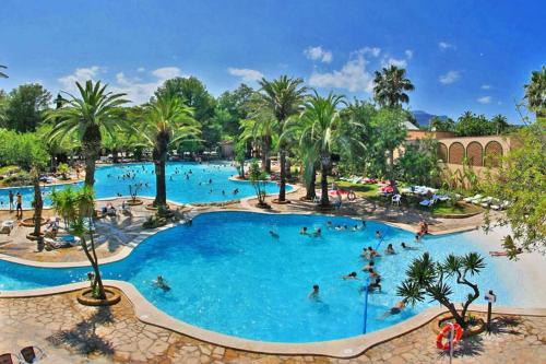 a large pool at a resort with people in it at Camping La Torre del Sol - Maeva Vacansoleil in Miami Platja