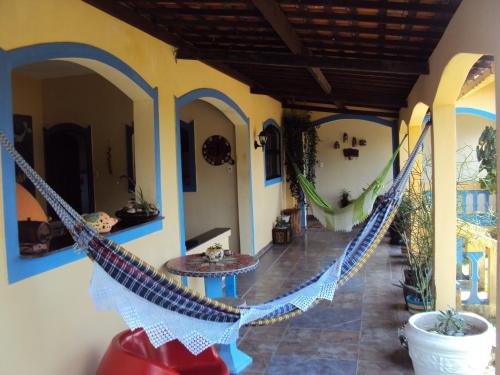 a porch with a hammock in a house at Casa Litoral Sul - Praia Bela/ PB in Pitimbu