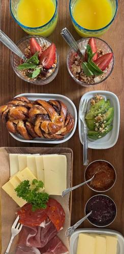 a table with several plates of food on it at Rosenhøj Bed and Breakfast in Svendborg