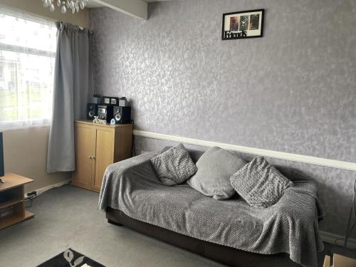 a bedroom with a couch with pillows on it at Captivating 2-Bed Chalet in Great Yarmouth in Great Yarmouth