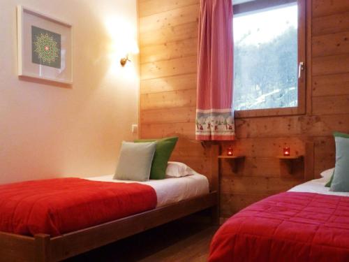 a bedroom with two beds and a window at Chalet Valloire, 6 pièces, 12 personnes - FR-1-263-156 in Valloire