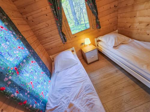Postel nebo postele na pokoji v ubytování Bursztynowa Osada