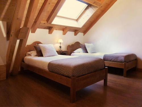 a bedroom with two beds and a skylight at Appartement Valloire, 3 pièces, 6 personnes - FR-1-263-153 in Valloire