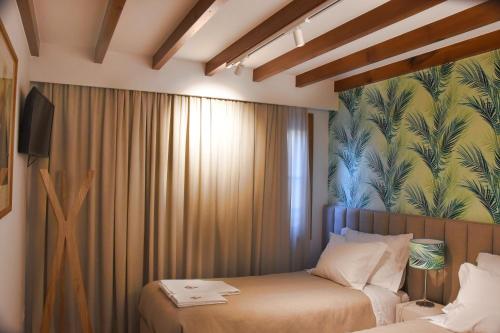 a hotel room with two beds and a tv at Family House Cup in Tomar