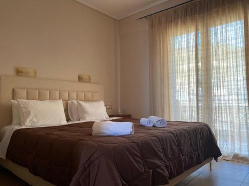 1 dormitorio con 1 cama con 2 toallas en Άλκηστις Alkistis, en Loutra Edipsou