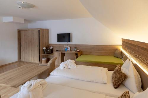 a hotel room with a bed and a tv at Hotel Turracherhof in Turracher Hohe