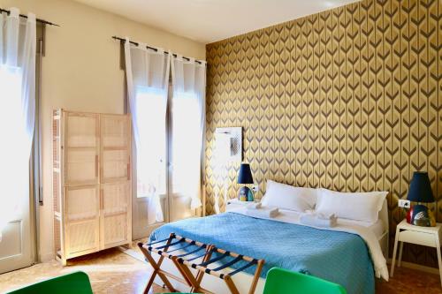 a bedroom with a bed and two chairs in it at GUEST HOUSE SONNINO 37 in Cagliari