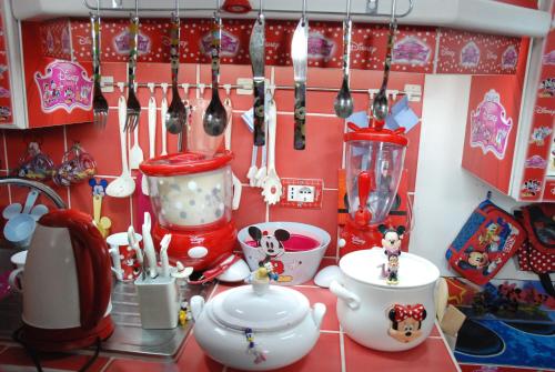 a kitchen counter with utensils and other kitchen items at Comics Factory Airport & City in Catania