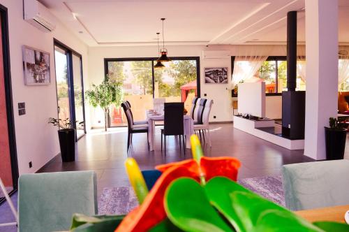 a dining room and living room with a table and chairs at Villa Riad Arabic House Pool & Spa in Marrakech