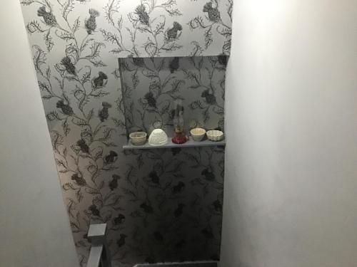 a bathroom with a shower with a wall at Hundalee House in Jedburgh