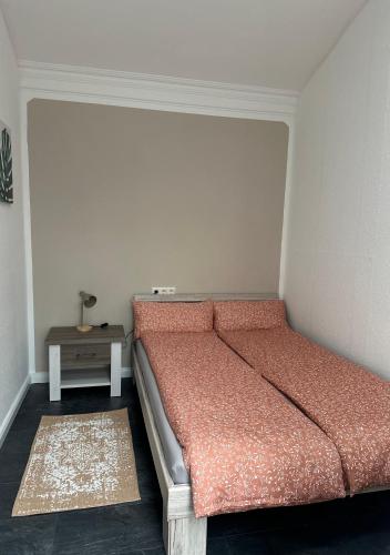 a bed in a room with a small table at Ferienwohnung Steinebach in Steinebach