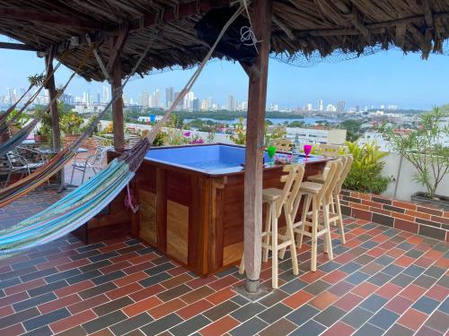 a hammock on a patio with a view of the city at La Terraza de Estella in Cartagena de Indias