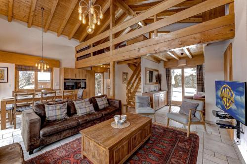 a living room with a couch and a table at Chalet Coeur in La Tzoumaz