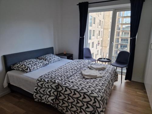 a bedroom with a bed and a large window at A charming apartment in the heart of Copenhagen in Copenhagen