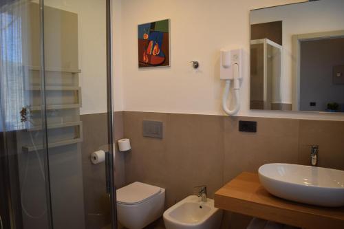 a bathroom with a toilet and a sink and a shower at Agriturismo Le Arcate in Sinio